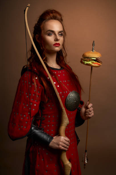 istock Female fighter keeping bow and arrow with hamburger 1147771045