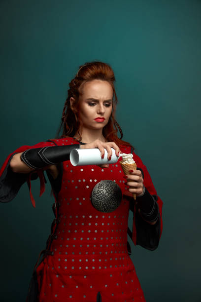 istock Red haired female warrior eating delicious ice cream 1147771061