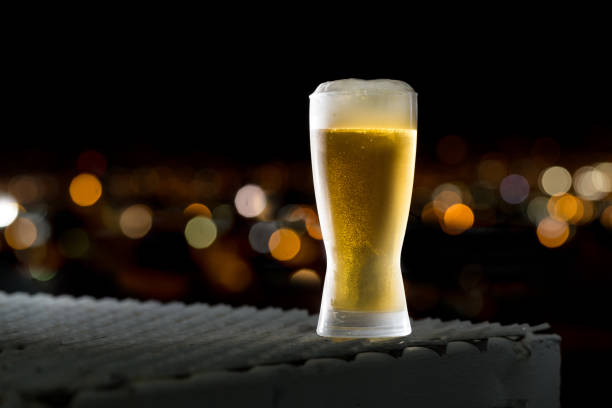 istock Beer glass over blurred cityscape background 1147772323