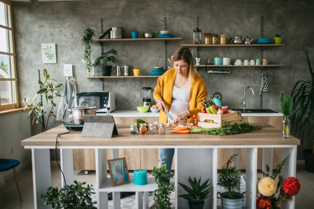 istock Beautiful pregnant woman cooking 1147776042