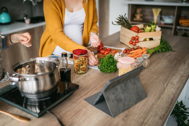 istock Friends cooking for their cooking blog 1147776255