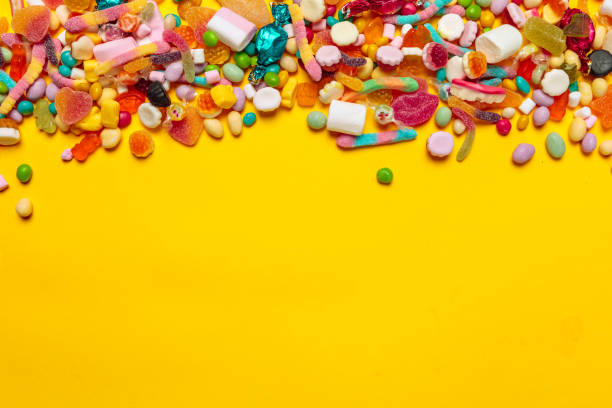 istock colored candies on yellow background 1147779918