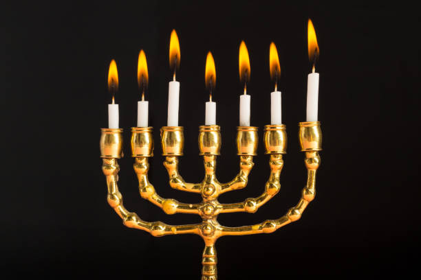istock Bronze Hanukkah menorah with burning candles 1147780979