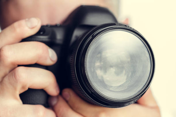 istock photographer with camera in hand 1147781660