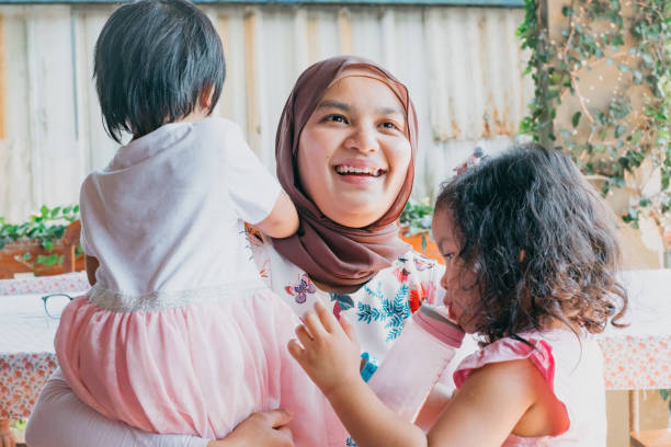 istock mom and daughters laughing 1147783977
