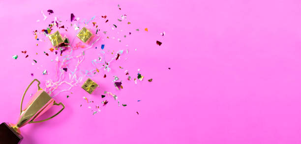 istock Celebrating the success that has happened, Gold trophy placed on a pink background. 1147785489