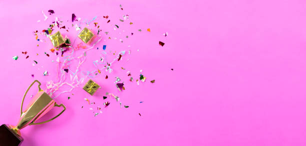 celebrating the success that has happened, gold trophy placed on a pink background. - copy space single object confetti nobody imagens e fotografias de stock