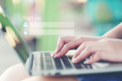 Young woman using laptop computer and sign up or log in username password in coffee shop,GDPR.cyber security and privacy concept