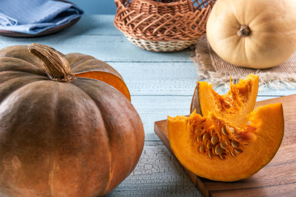 istock Pumpkins and slices with seeds on cutting board 1147789337