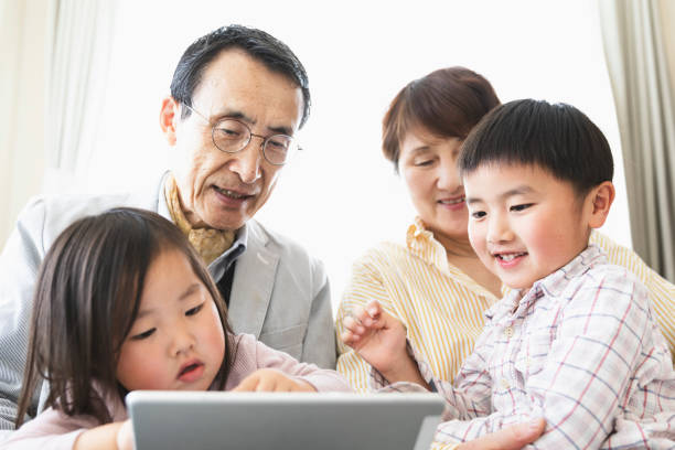 istock Grandparents and grandchildren using a tablet pc together 1147789948