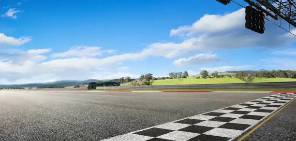 Wide angle view empty asphalt international race track with start and finish line , morning scene .