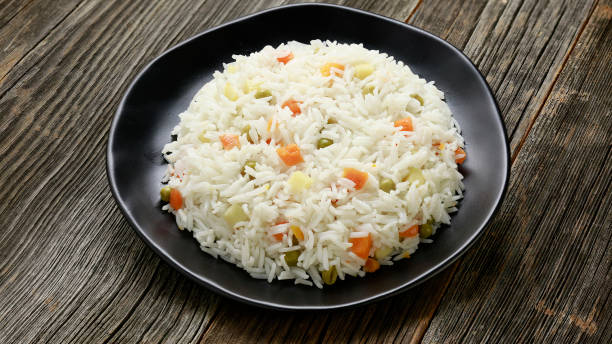 istock rice with lentil and vegetables on wood background 1147790676