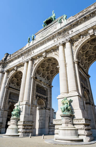 istock Low angle view of the arcade du Cinquantenaire in Brussels, Belgium, against blue sky. 1147790912