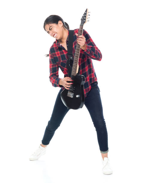istock Beautiful young latino female playing an electrical guitar 1147792313