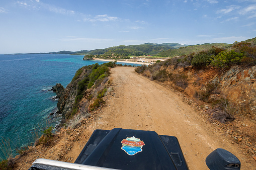 Sithonia, Chalkidiki, Greece - June 27, 2014: SUV car Land Rover Defender 110 driving on the off-road