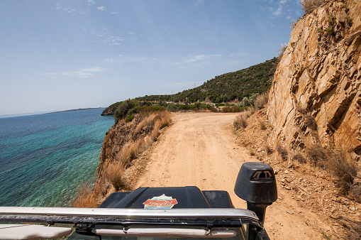Sithonia, Chalkidiki, Greece - June 27, 2014: SUV car Land Rover Defender 110 driving on the off-road