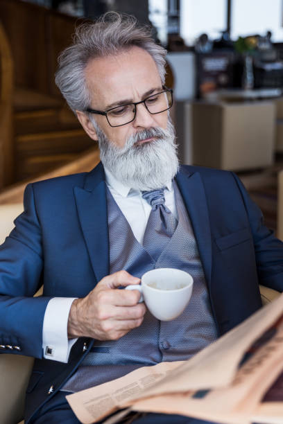 istock Classy dressed senior businessman having good time coffeehouse 1147795791