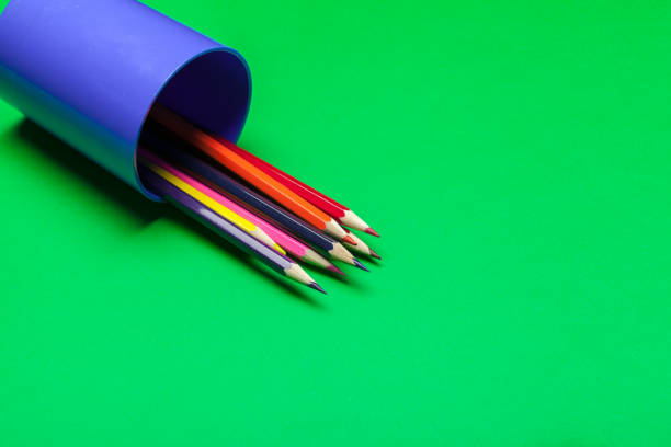 istock Colorful pencils on a bright green paper background 1147796018