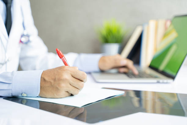 istock Asian doctor works at the computer in clinic office - Image 1147796684