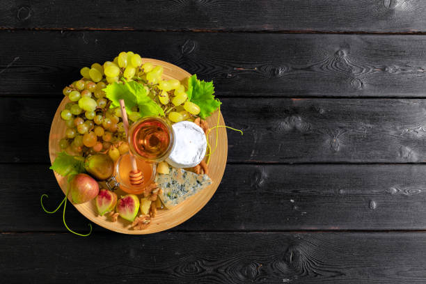 istock wine with branches of white grapes. On a wooden table. 1147798205