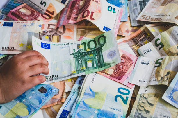 istock child stealing one hundred euro banknote on more euro banknotes 1147799156