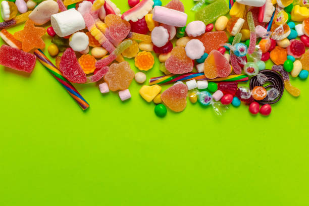istock Colorful candies on green background 1147800270