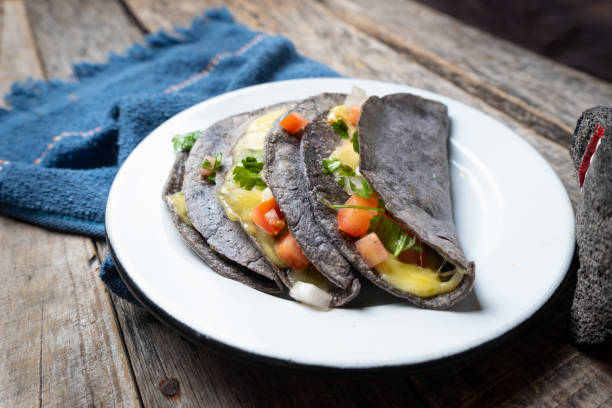 Quesadillas with blue corn tortillas and mexican sauce Authentic quesadillas with blue corn tortillas and mexican sauce fresh cilantro stock pictures, royalty-free photos & images