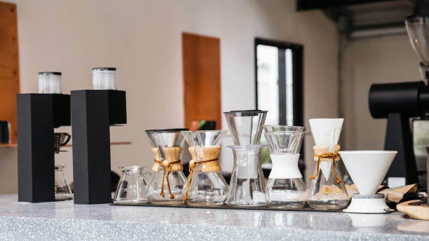 istock Coffee equipments with various sizes of drip coffee cups, drip paper and Espresso machine on marble top counter. 1147803687