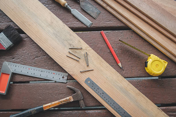 istock Equipment on wooden desk with man working in workshop background. 1147804812