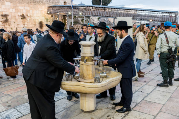 Jerusalem, Israel, January 09, 2007: An orthodox jew drinking. The sink is close to the wailing wall in Jerusalem.