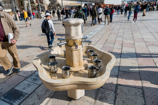 Silver natla or Jewish ritual hand washing cups lie in a marble sink near the Western Wall in Jerusalem.