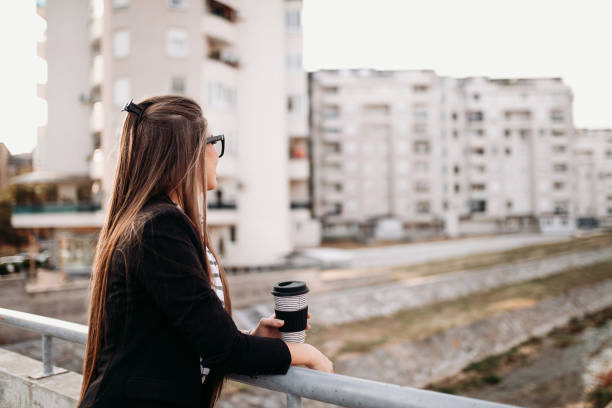 istock Woman drinking coffee outdoors 1147808160