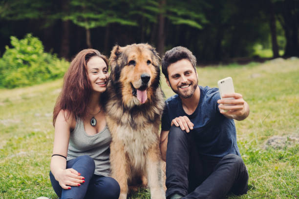 istock Couple with dog taking selfie 1147808548