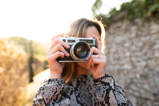 istock Teenage girl using a vintage camera 1147809931
