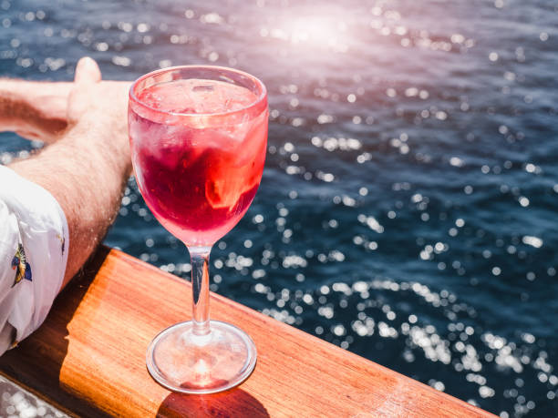 istock Wineglass with a pink cocktail and ice cubes 1147811582