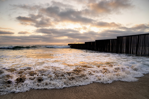 A beautiful sunset on the beach near the border wall between Tijuana, Mexico, and the United States