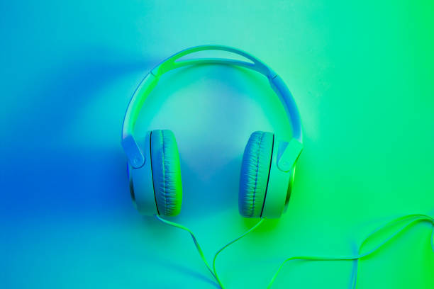 Headphones on colorful (multicolor tonal transitions) background. Poster layout with free text (copy) space.