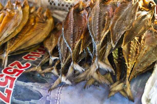 A Thailand open air market at Takuapa in the Khao Lak region, this is one of the largest markets in the region and is mainly frequented by locals. this image is a close-up of dried fish fillets on a stall.
