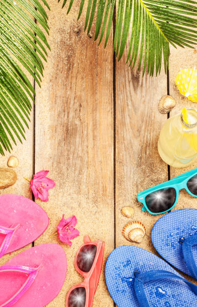Beach, palm tree leaves, sand, sunglasses and flip flops