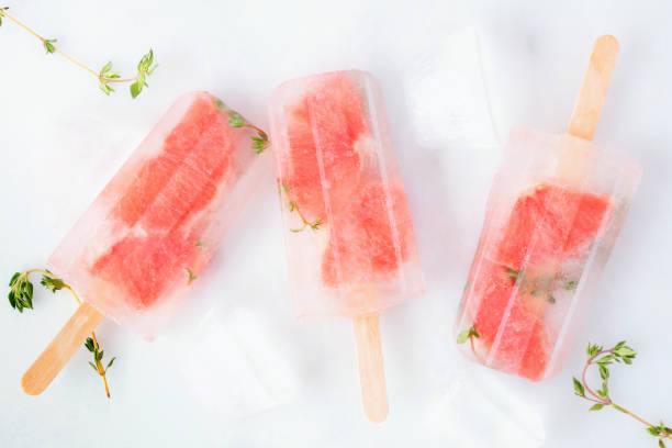 istock Healthy grapefruit and thyme popsicles, top view scattered on marble 1147819039