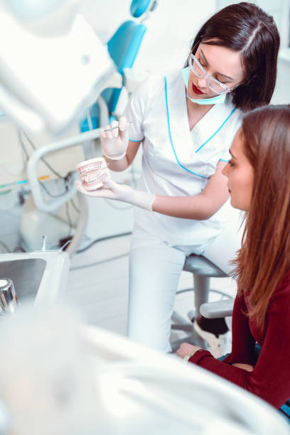 istock Female Patient Learning About Teeth Order From Dentist 1147823869