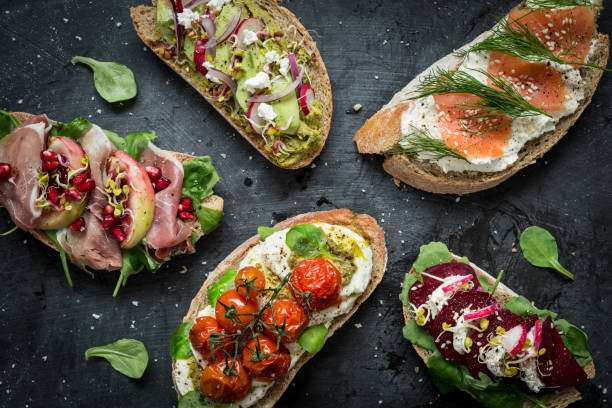 istock Different kinds of colorful sandwiches on black 1147824696