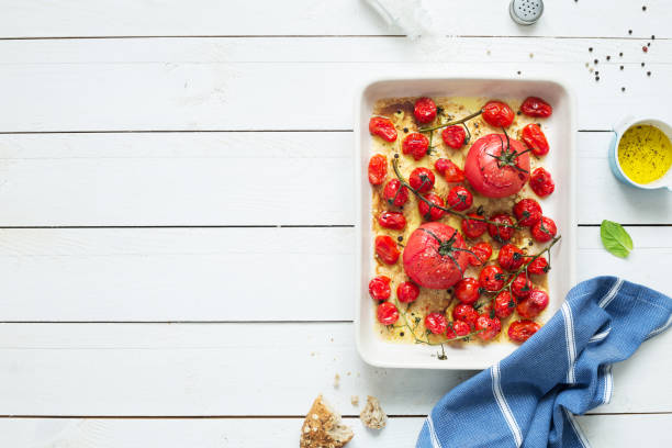 istock Roasted tomatoes in a ceramic dish on white wood 1147824712