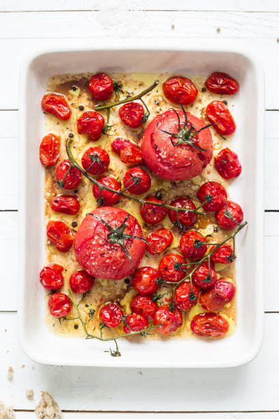 istock Roasted tomatoes in a ceramic dish on white wood 1147824713