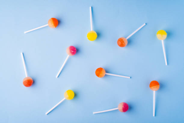 istock Scattered lollipop candies on blue background top view 1147825075