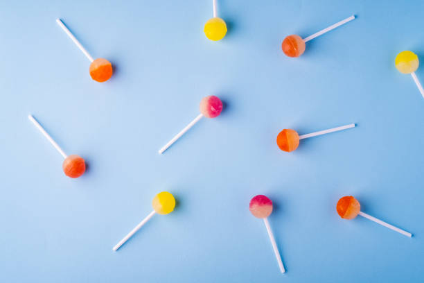 istock Scattered lollipop candies on blue background top view 1147825079