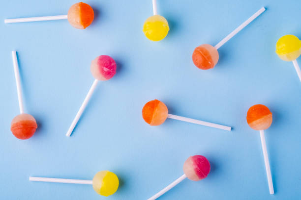 istock Scattered lollipop candies on blue background top view 1147825169