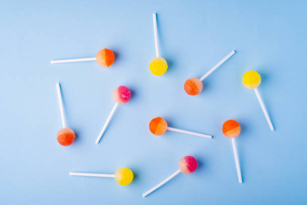 istock Scattered lollipop candies on blue background top view 1147825623