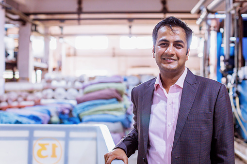 Business, India, Factory - Young Businessman Standing at his Factory and Looking at the Camera for a Portrait