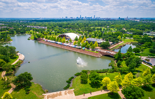 Austin Mueller Suburb Mueller Pond in east side with Austin skyline far in the background with water foundation and festival farmer’s market